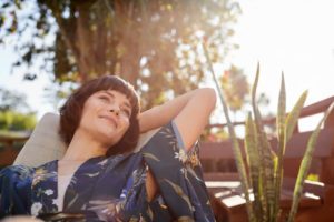 A woman relaxes on a patio lounge